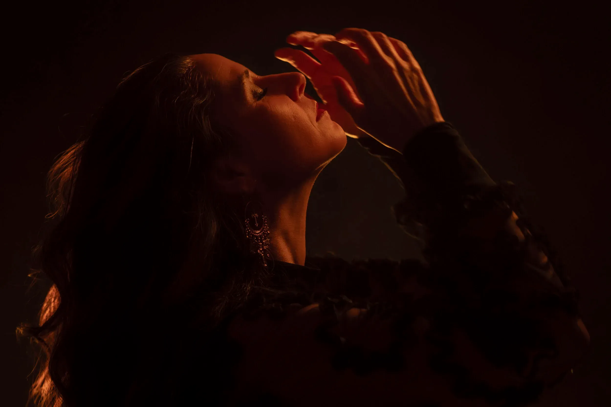 A warm low-light portrait in profile